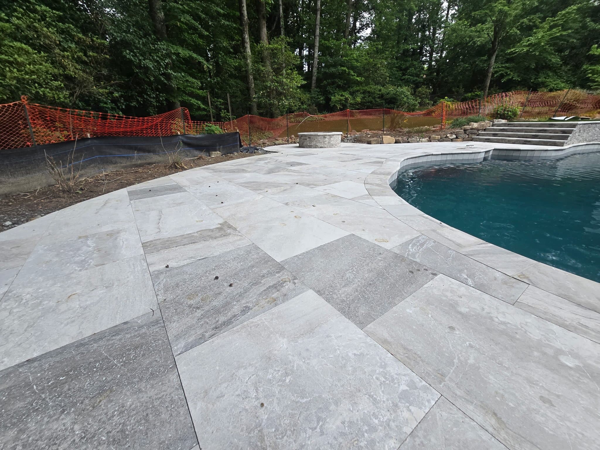 Travertine paver deck detail with freeform pool edge