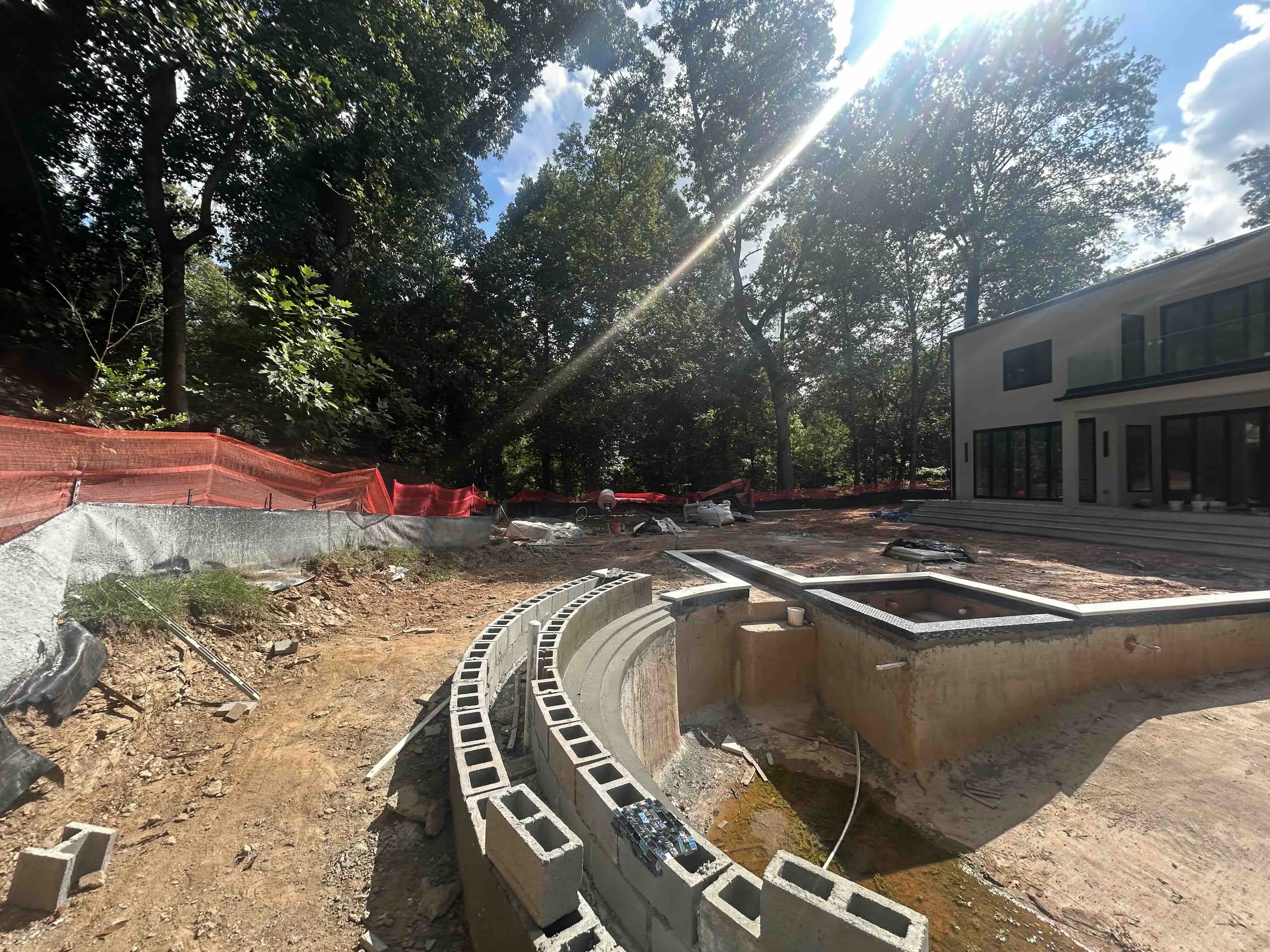 Modern contemporary pool and spa mid-construction with retaining walls in Atlanta