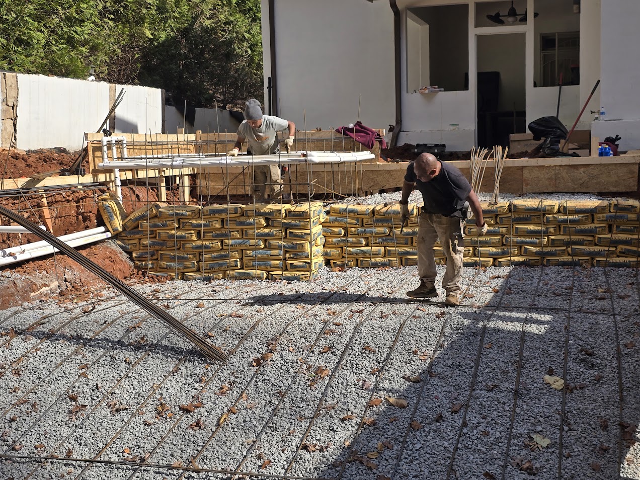 Hand-tied steel rebar cage forming the structure of a pool before shotcrete application